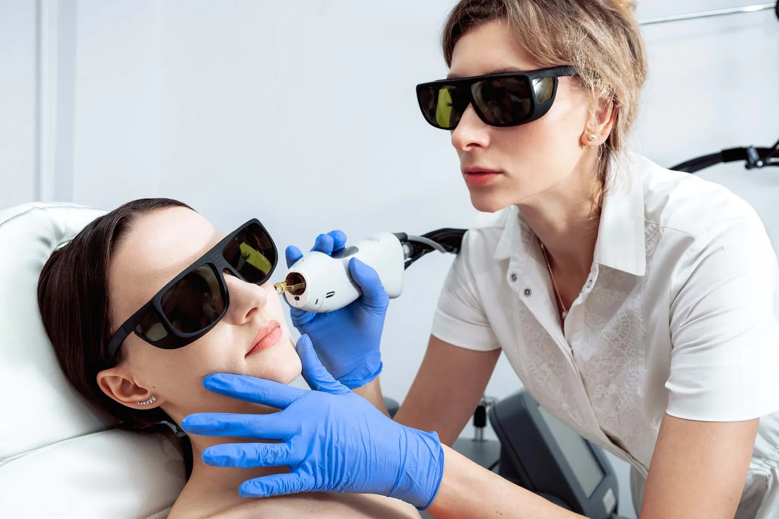 Skin Care. Young Woman Receiving Facial Beauty Treatment, Removing Pigmentation At Cosmetic Clinic. Intense Pulsed Light Therapy. IPL. Rejuvenation, Photo Facial Therapy. Anti-aging Procedures.