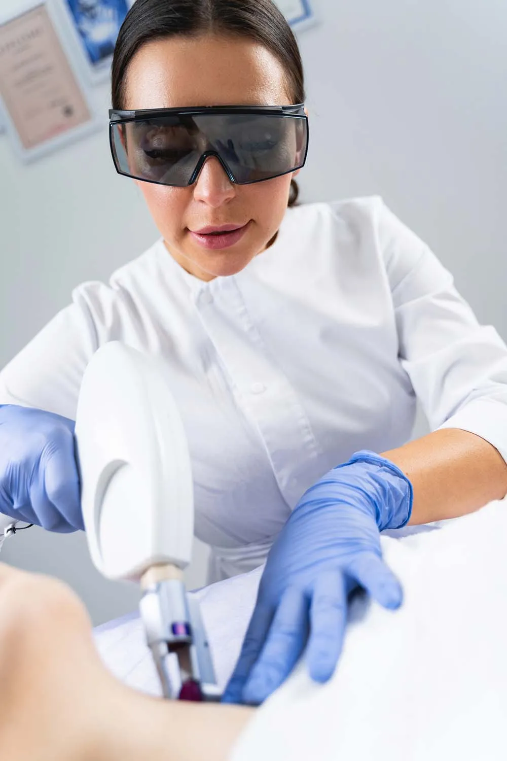 Dermatologist smoothing fine lines on her patients neck